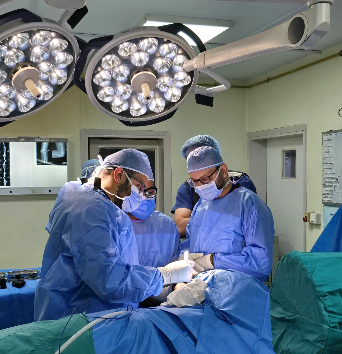 Dr. Shoaib Arshad operating in theatre with the surgical team