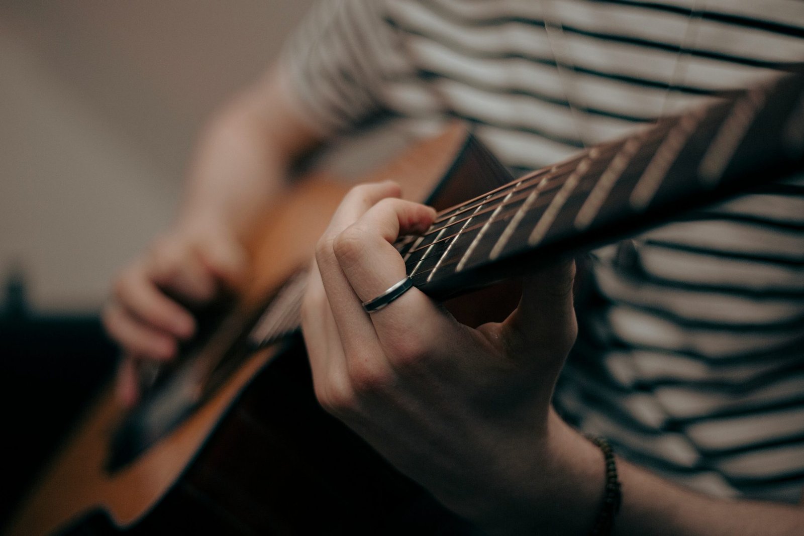 Hands playing a guitar after recovery